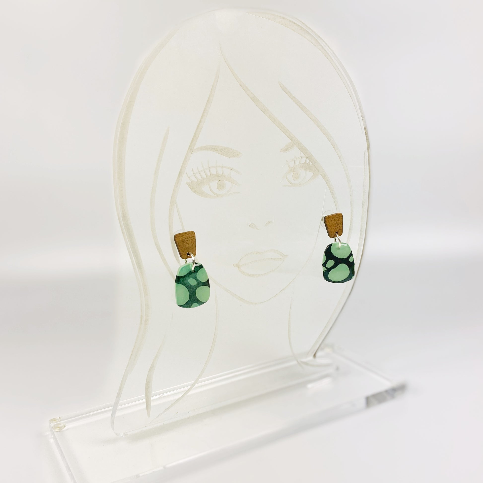 Midnight Forest Handmade Polymer Clay Dangle Earrings on an acrylic display head
