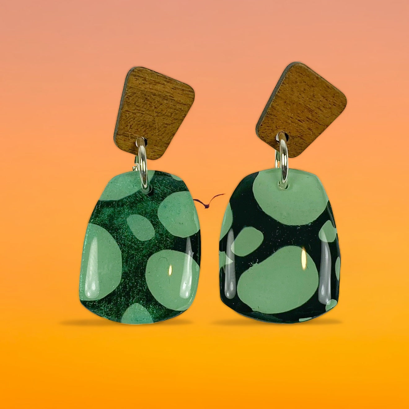 Midnight Forest Handmade Polymer Clay Dangle Earrings on a graduated orange background