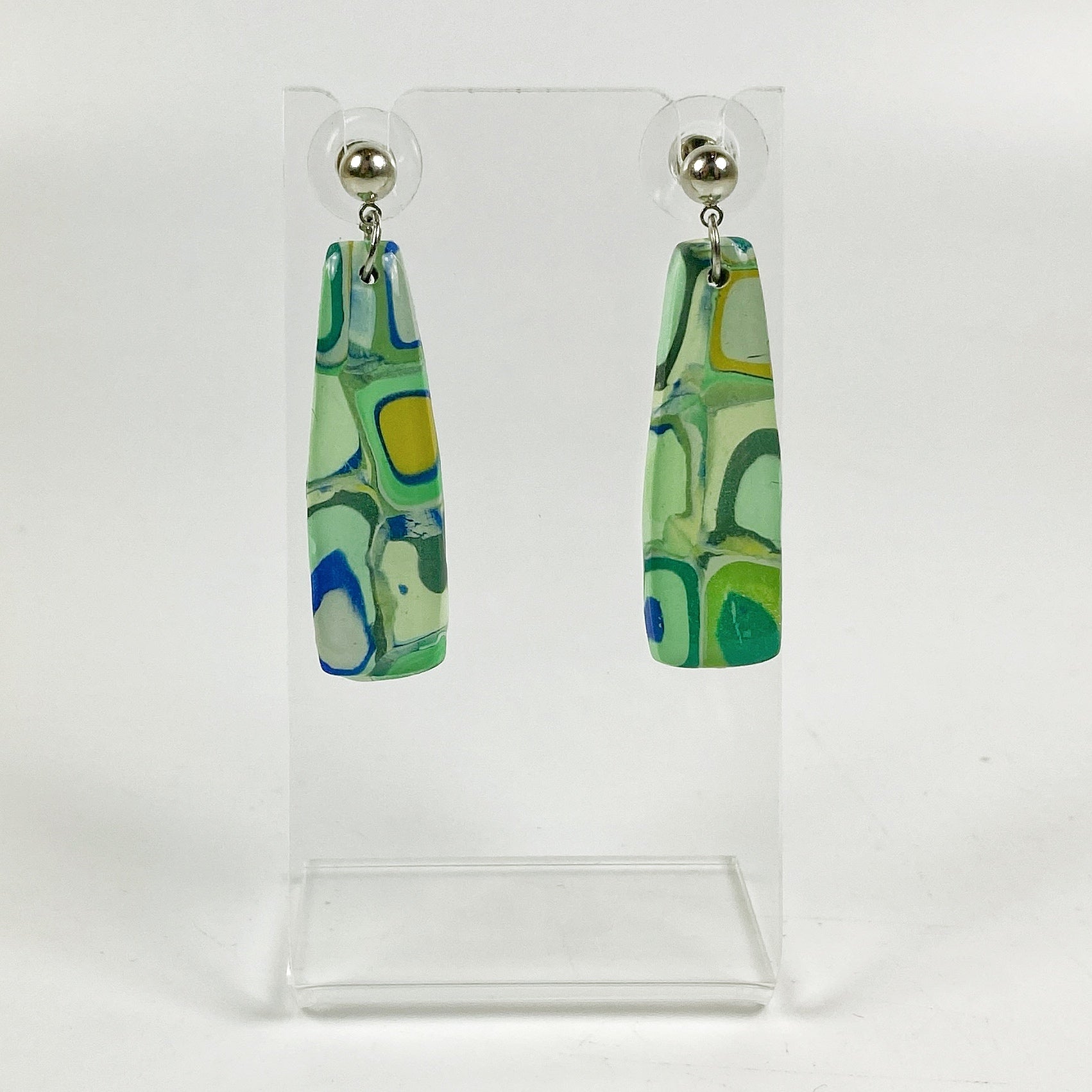 Squares of Green Polymer Clay Handmade Dangle Earrings on an acrylic earring stand
