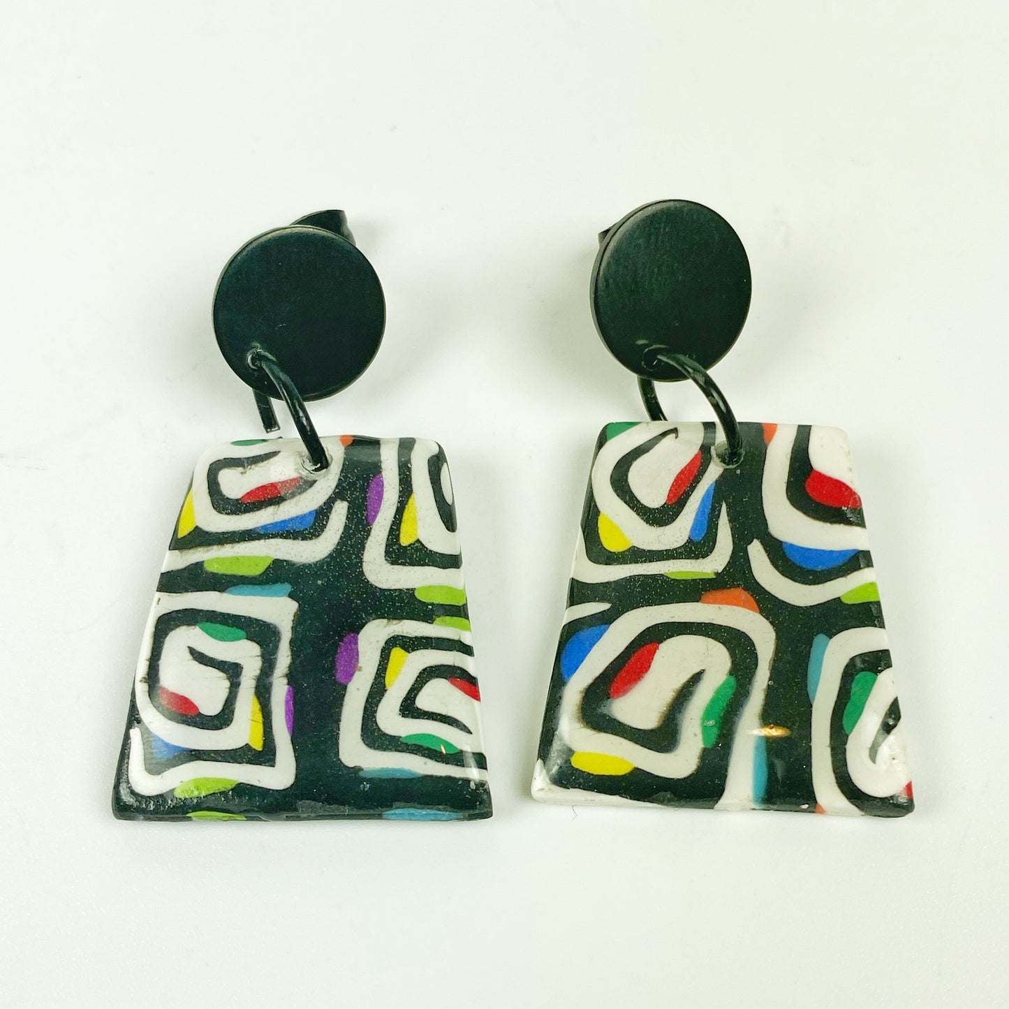 Midnight Spiral Polymer Clay Handmade Dangle Earrings on a neutral background