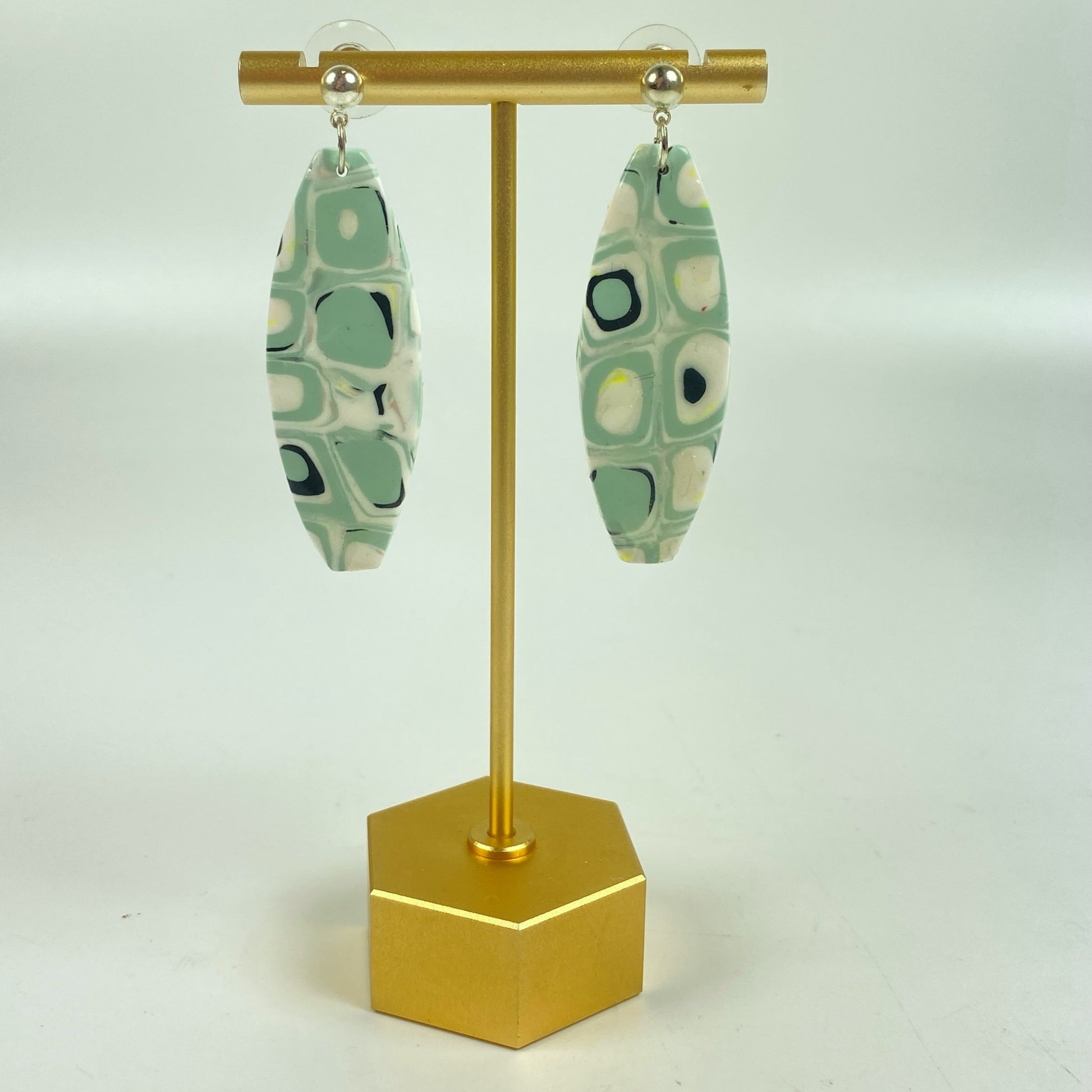 Dreamy Mint Noir Earrings on a brass earrings stand