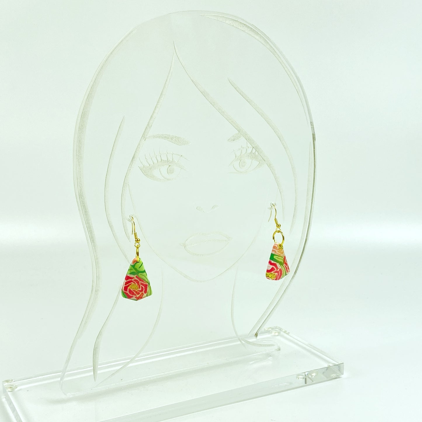 Whispering Roses Handmade Polymer Clay Dangle Earrings on an acrylic display head