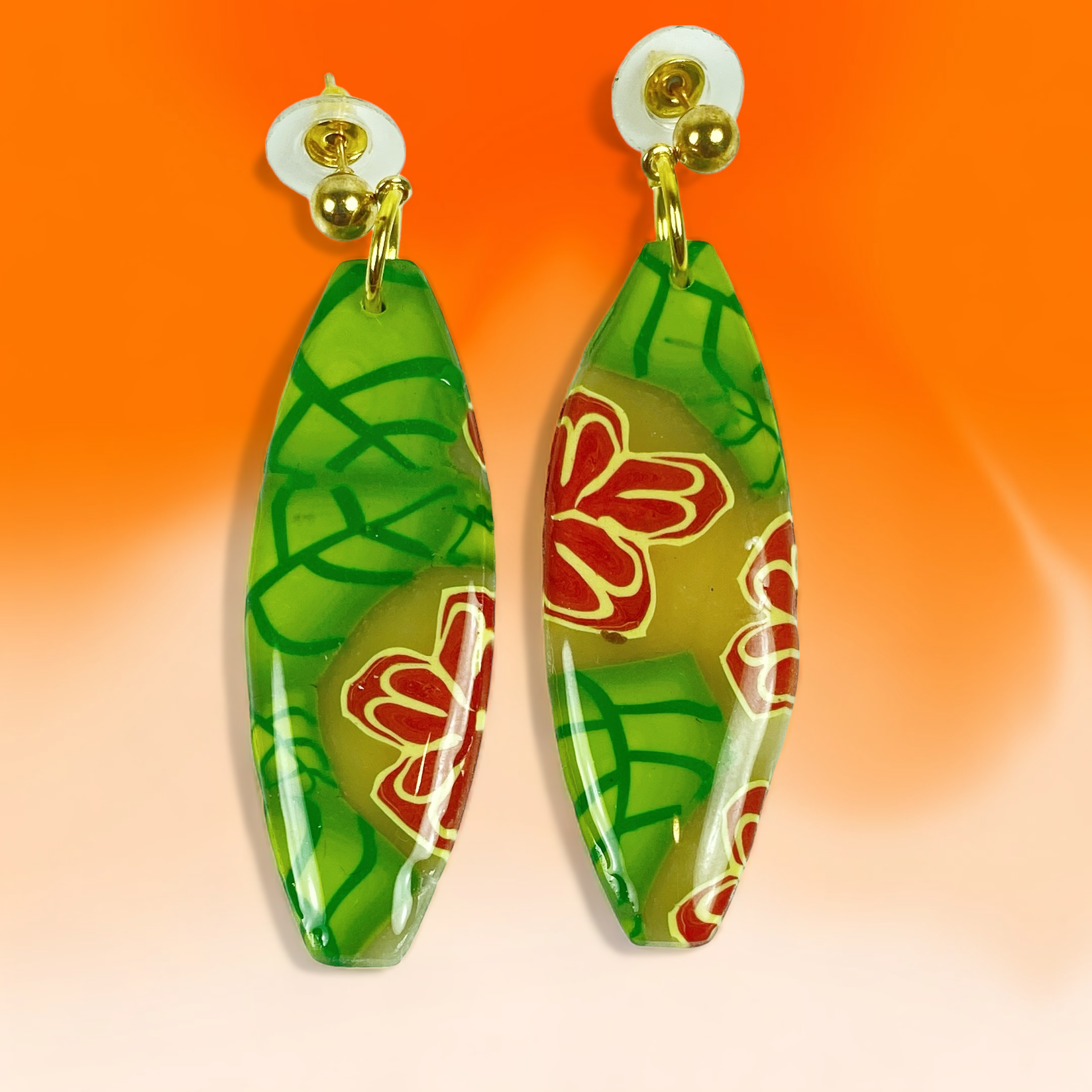 Island Bloom Handmade Polymer Clay Dangle Earrings on an orange background