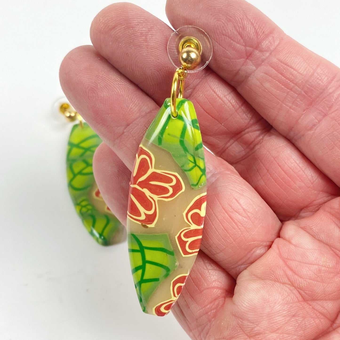 Island Bloom Handmade Polymer Clay Dangle Earrings handheld for size reference