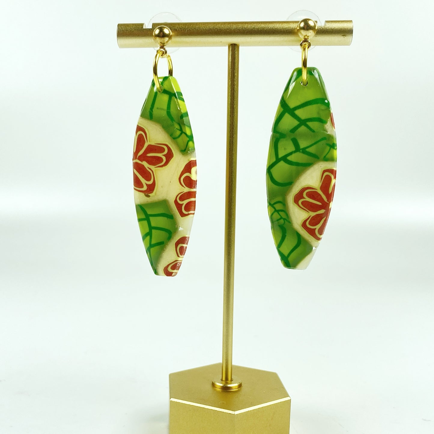 Island Bloom Handmade Polymer Clay Dangle Earrings on a brass earrings stand