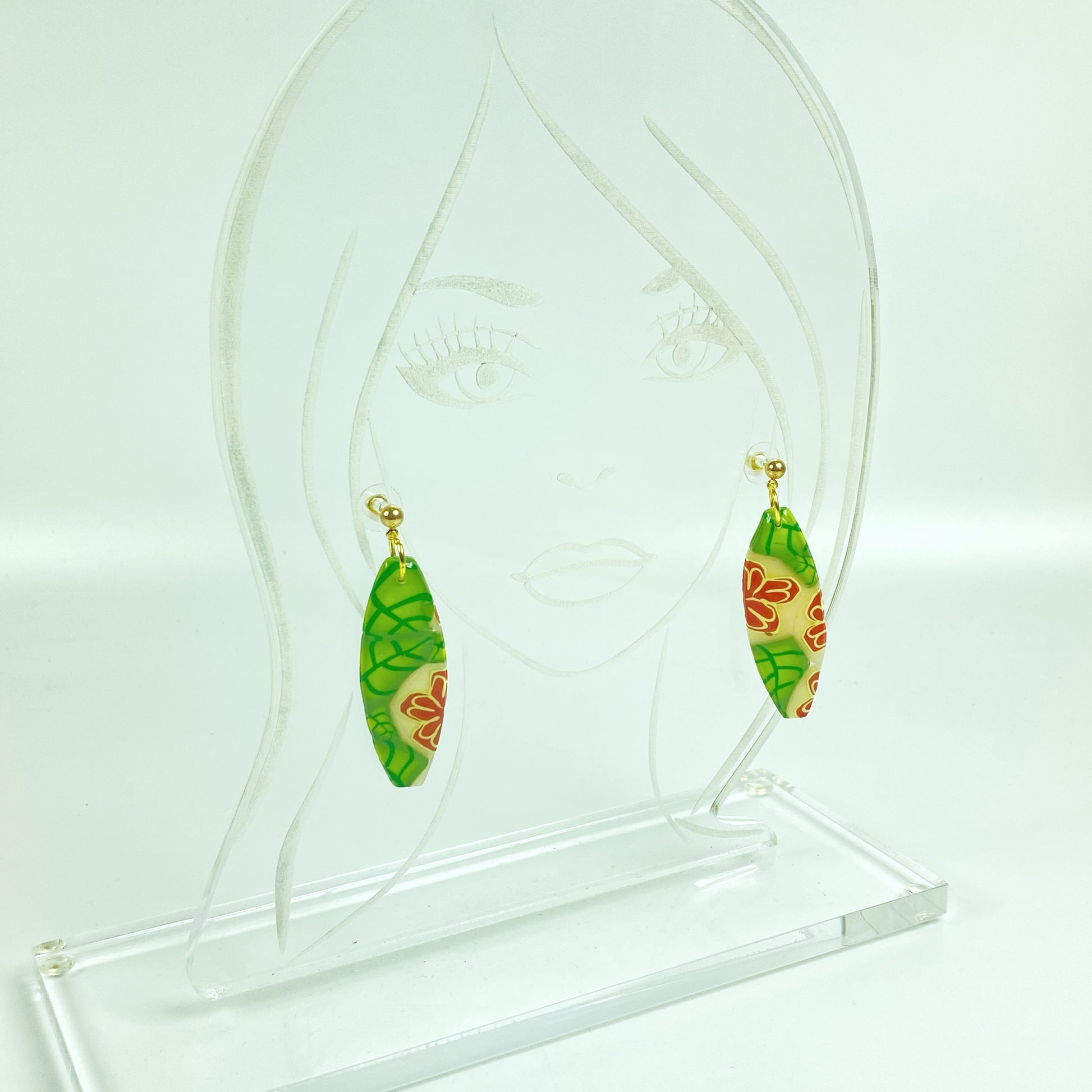 Island Bloom Handmade Polymer Clay Dangle Earrings on an acrylic display head