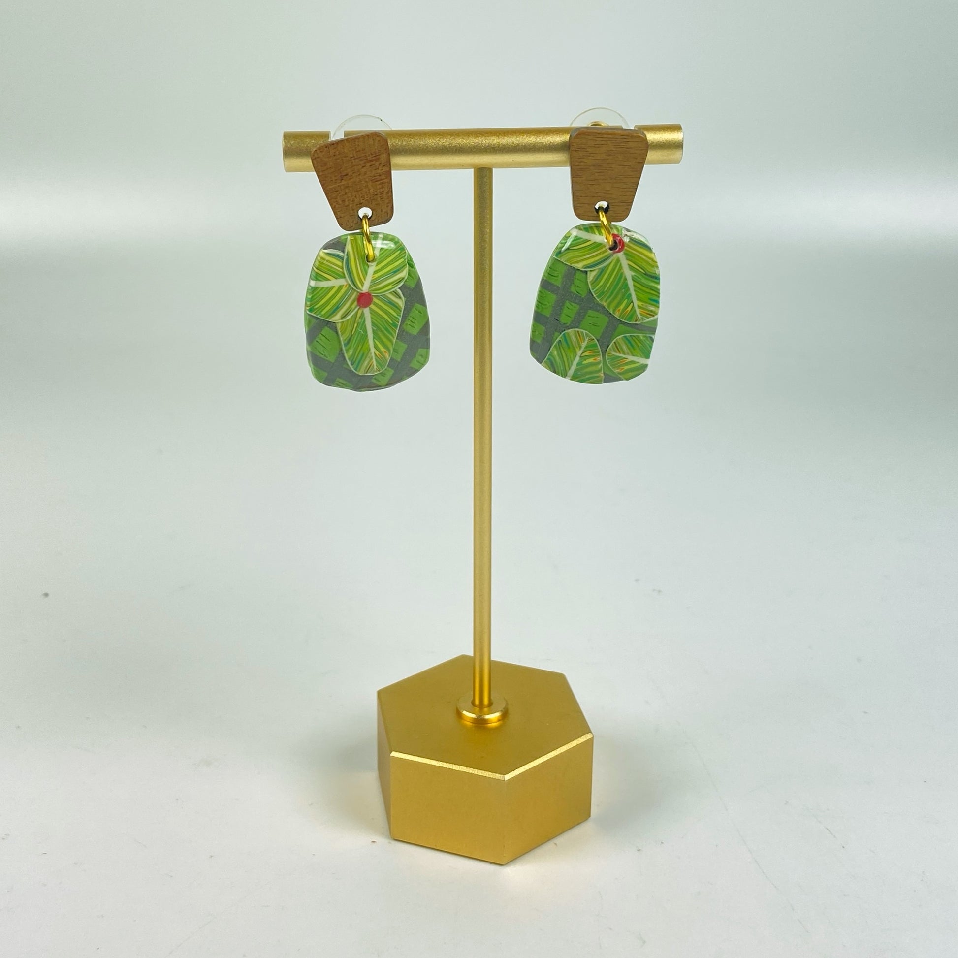 Jungle Canopy Handmade Polymer Clay Dangle Earrings on a brass display stand