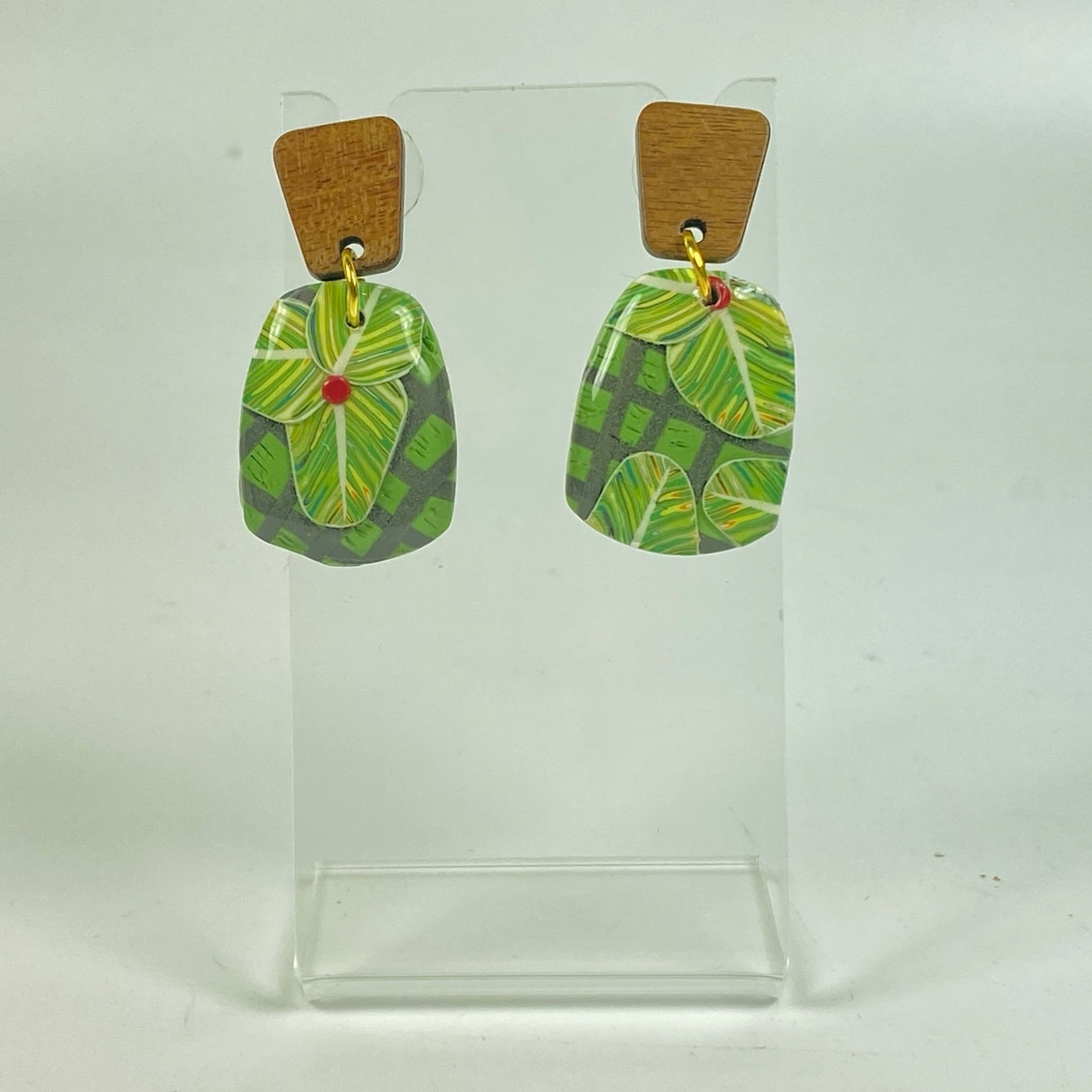 Jungle Canopy Handmade Polymer Clay Dangle Earrings on a small acrylic display stand
