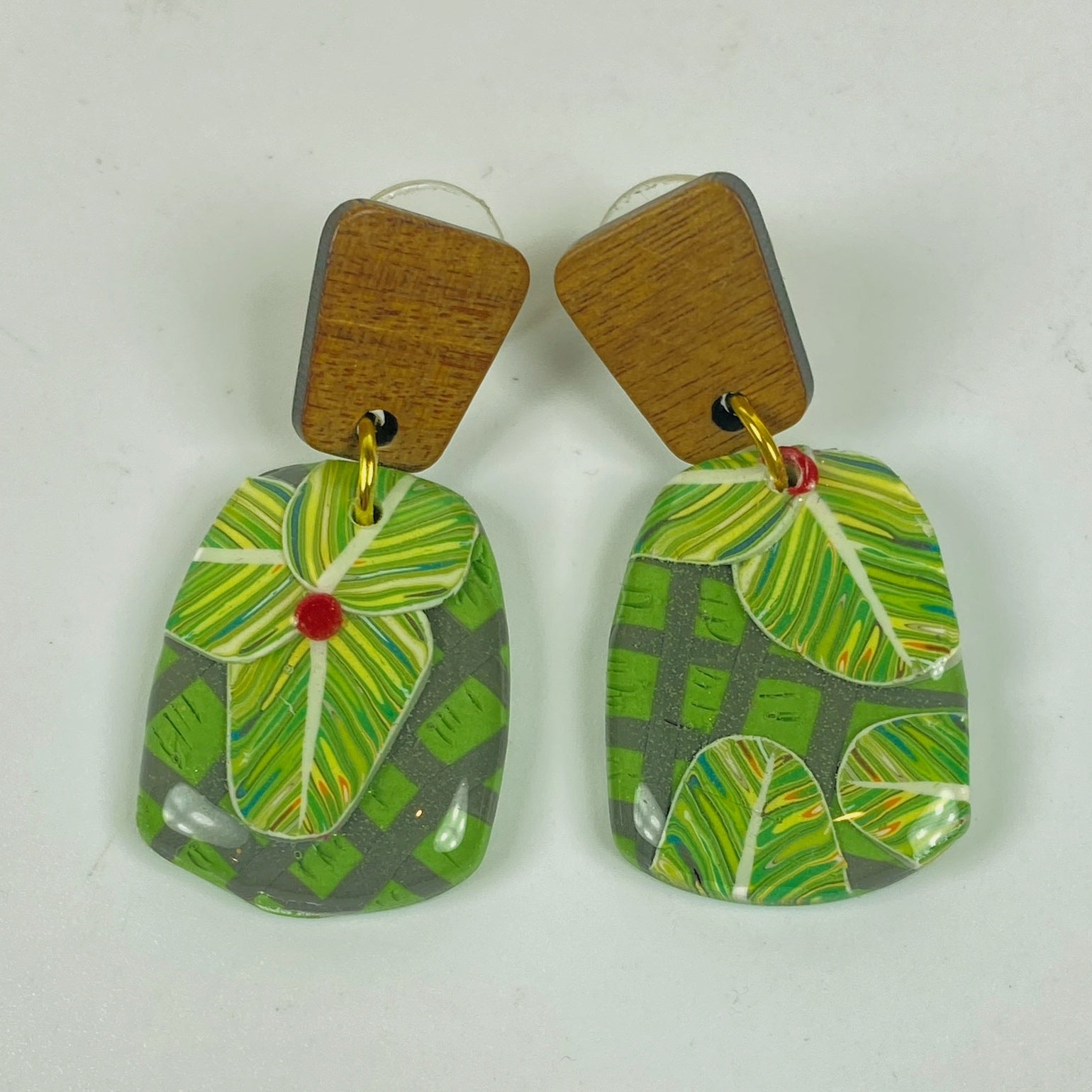 Jungle Canopy Handmade Polymer Clay Dangle Earrings on a plain background