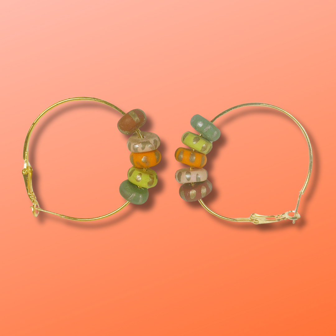 Handmade Polymer Clay Hoop Earrings with Autumn Beads on coral background