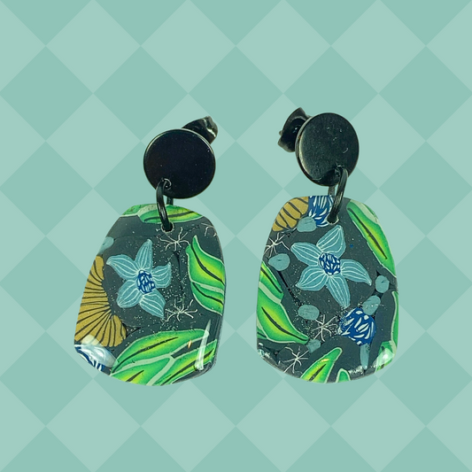 Blue Blossom Handmade Polymer Clay Earrrings on a green background