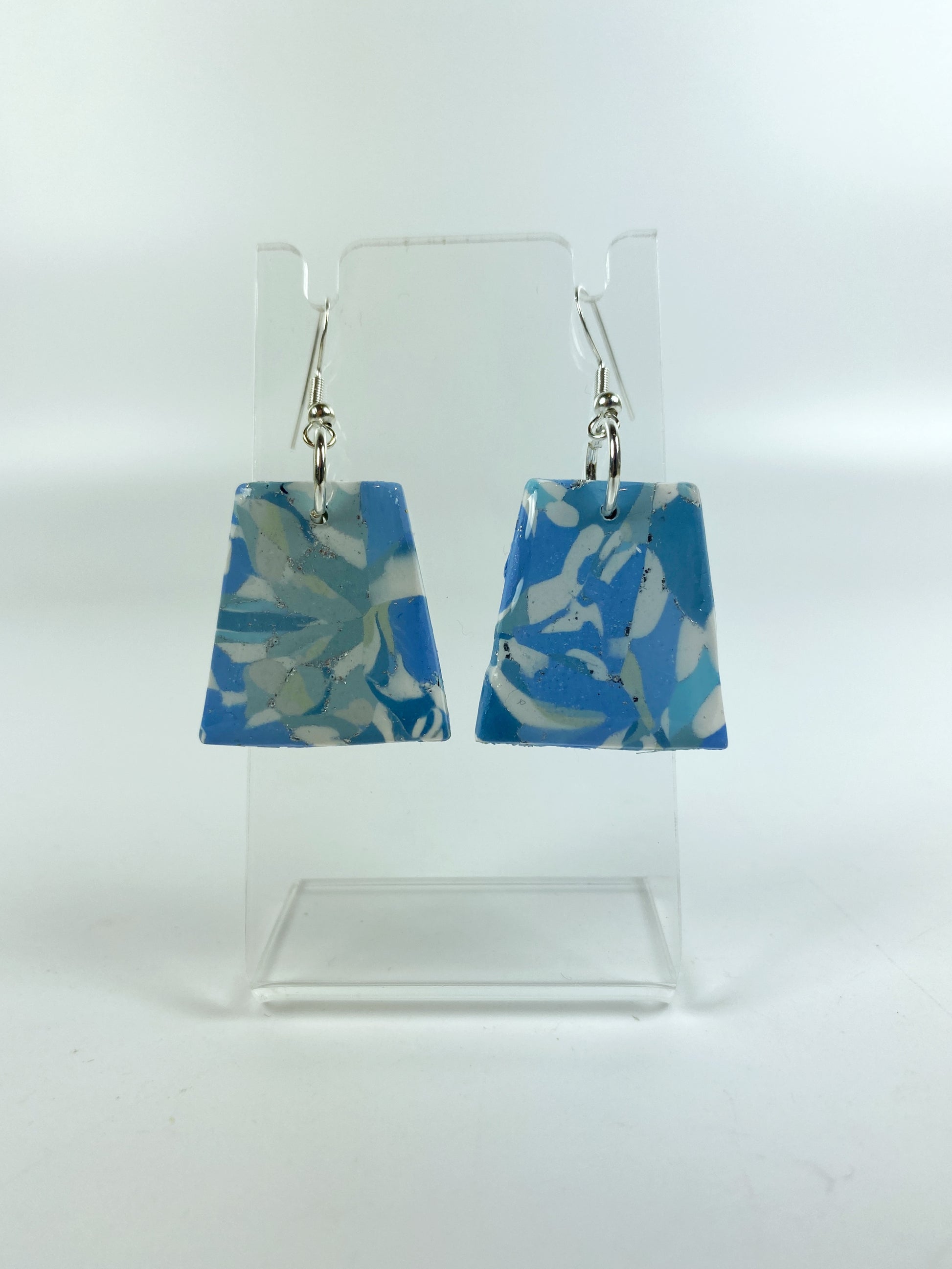 Moody Blue Handmade Polymer Clay Dangle Trapezoid Earrings on small acrylic stand