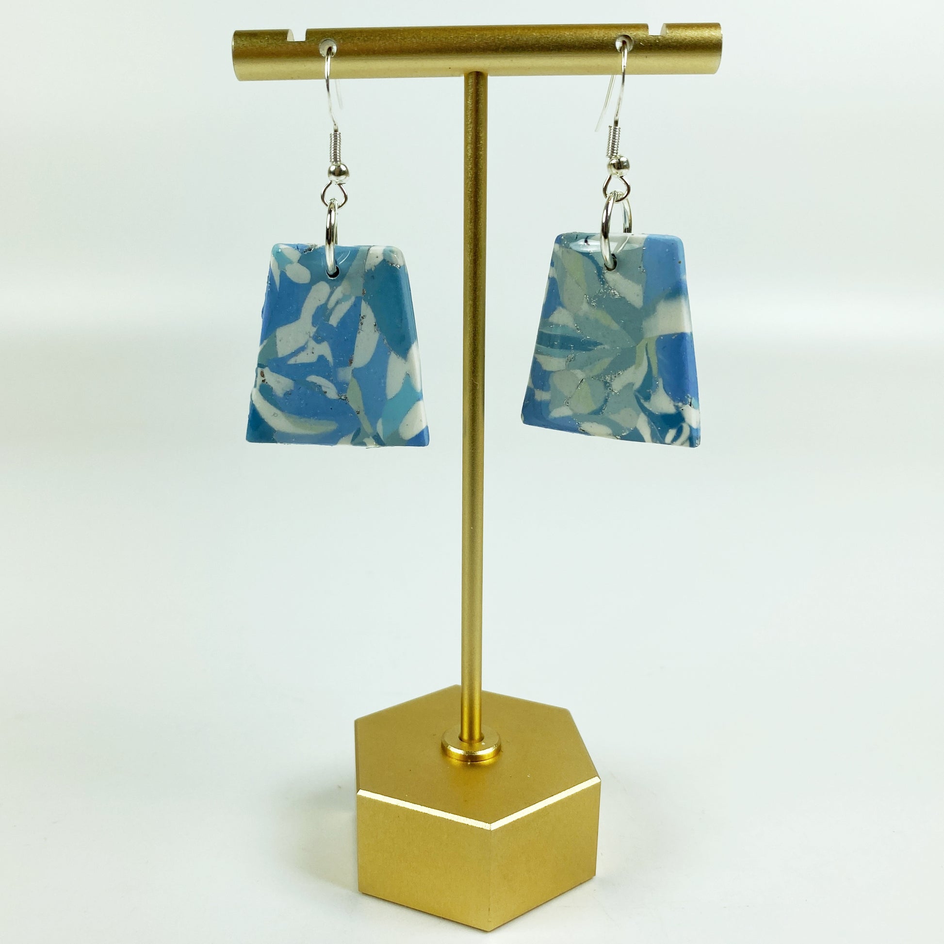 Moody Blue Handmade Polymer Clay Dangle Trapezoid Earrings on brass earring stand