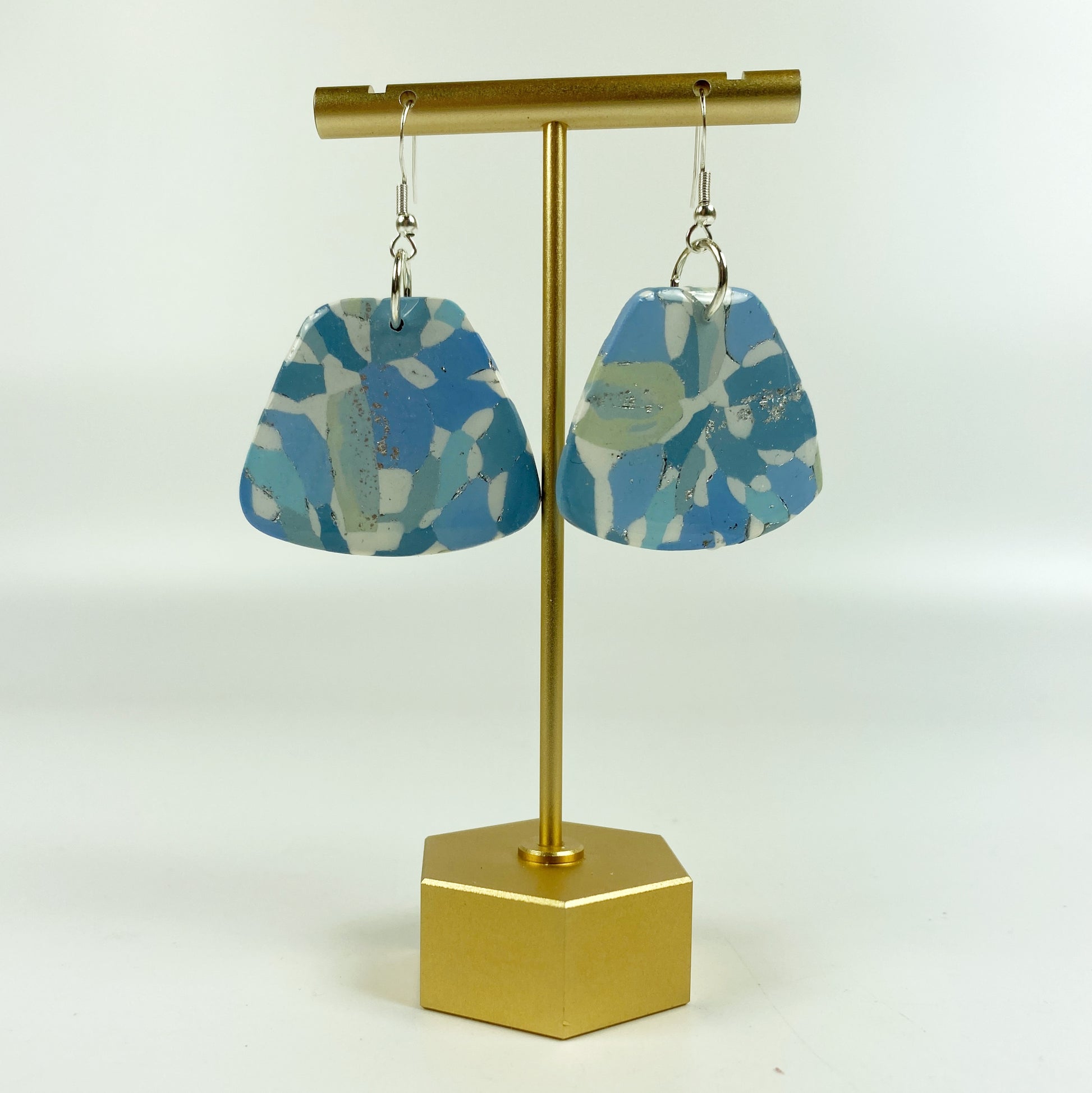 Moody Blue Handmade Polymer Clay Dangle Sleek Symmetry Earrings on a brass earring stand