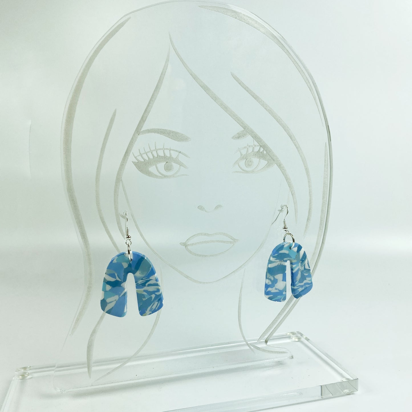 Moody Blue Handmade Polymer Clay Dangle Rainbow Shaped Earrings on acrylic display head