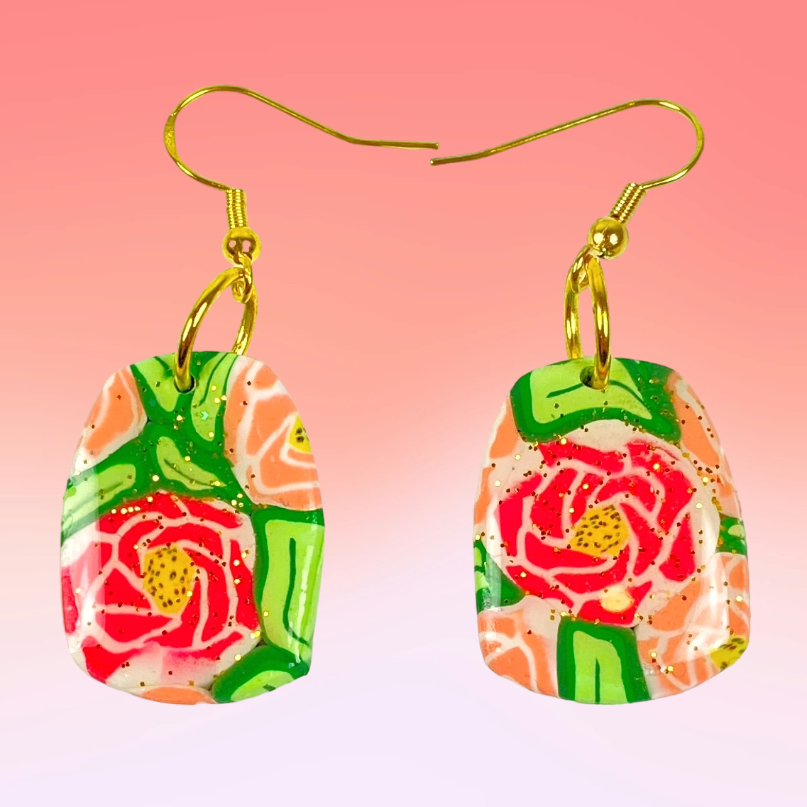 The Roses Handmade Polymer Clay Dangle Earrings on graduated pink backgroune