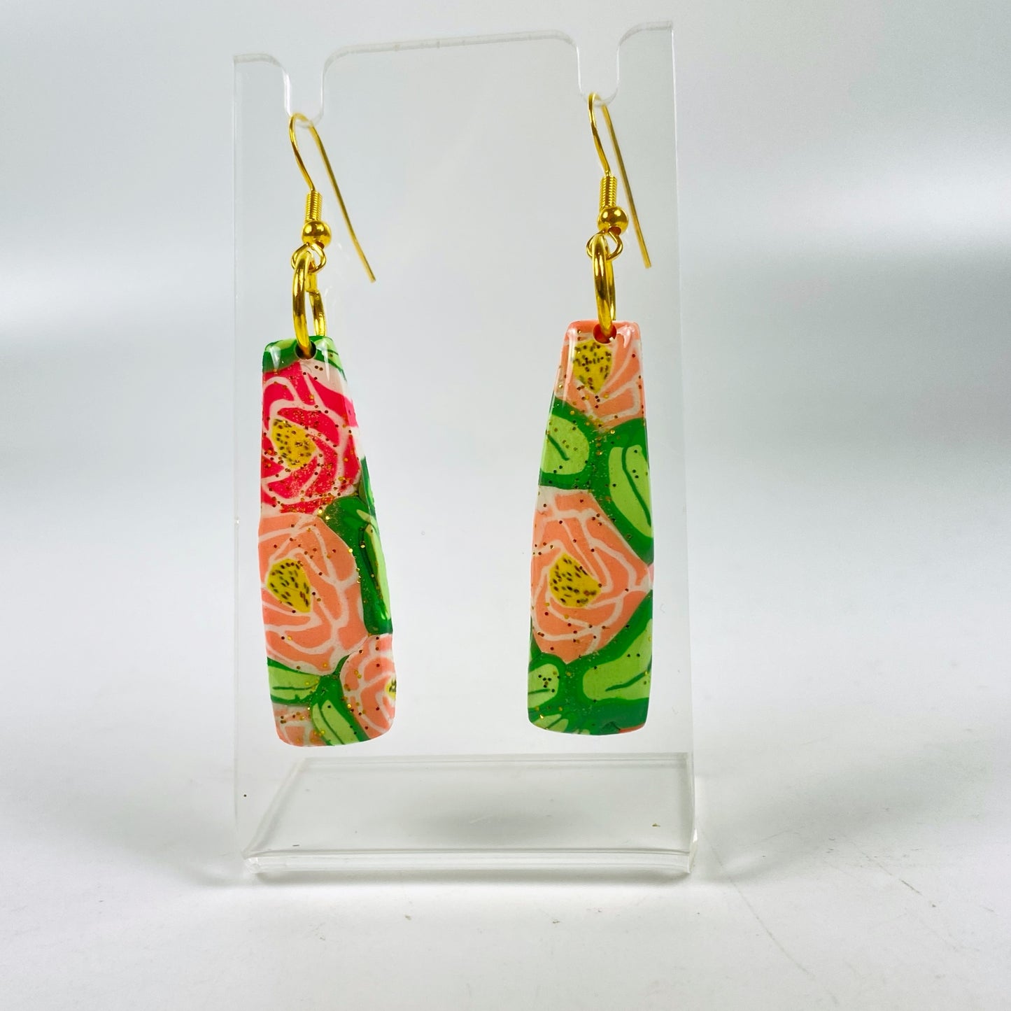 Rose Garden Handmade Polymer Clay Dangle Earrings on an acrylic display stand