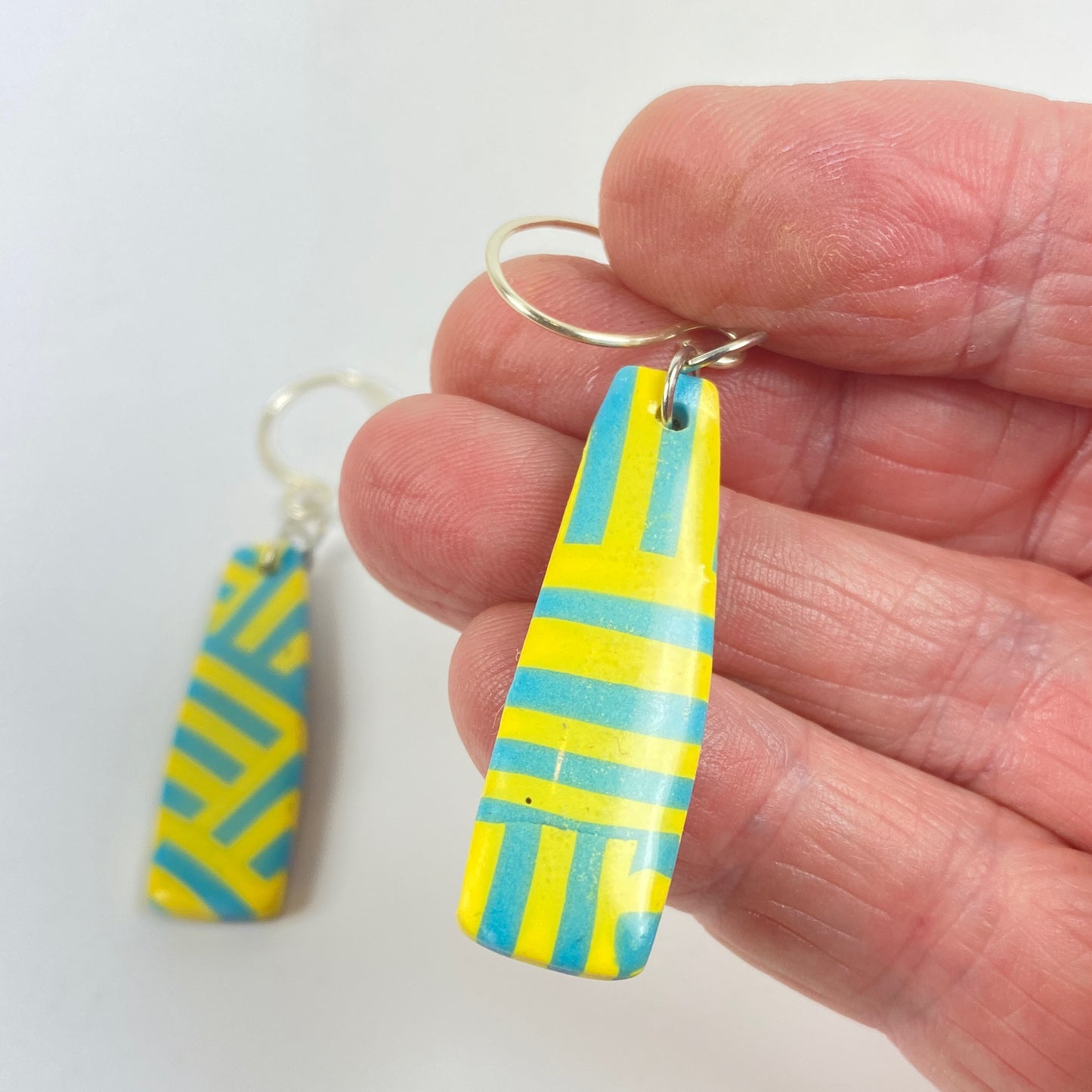 Turquoise & Yellow Braid Handmade Polymer Clay Dangle Earrings handheld for size comparison
