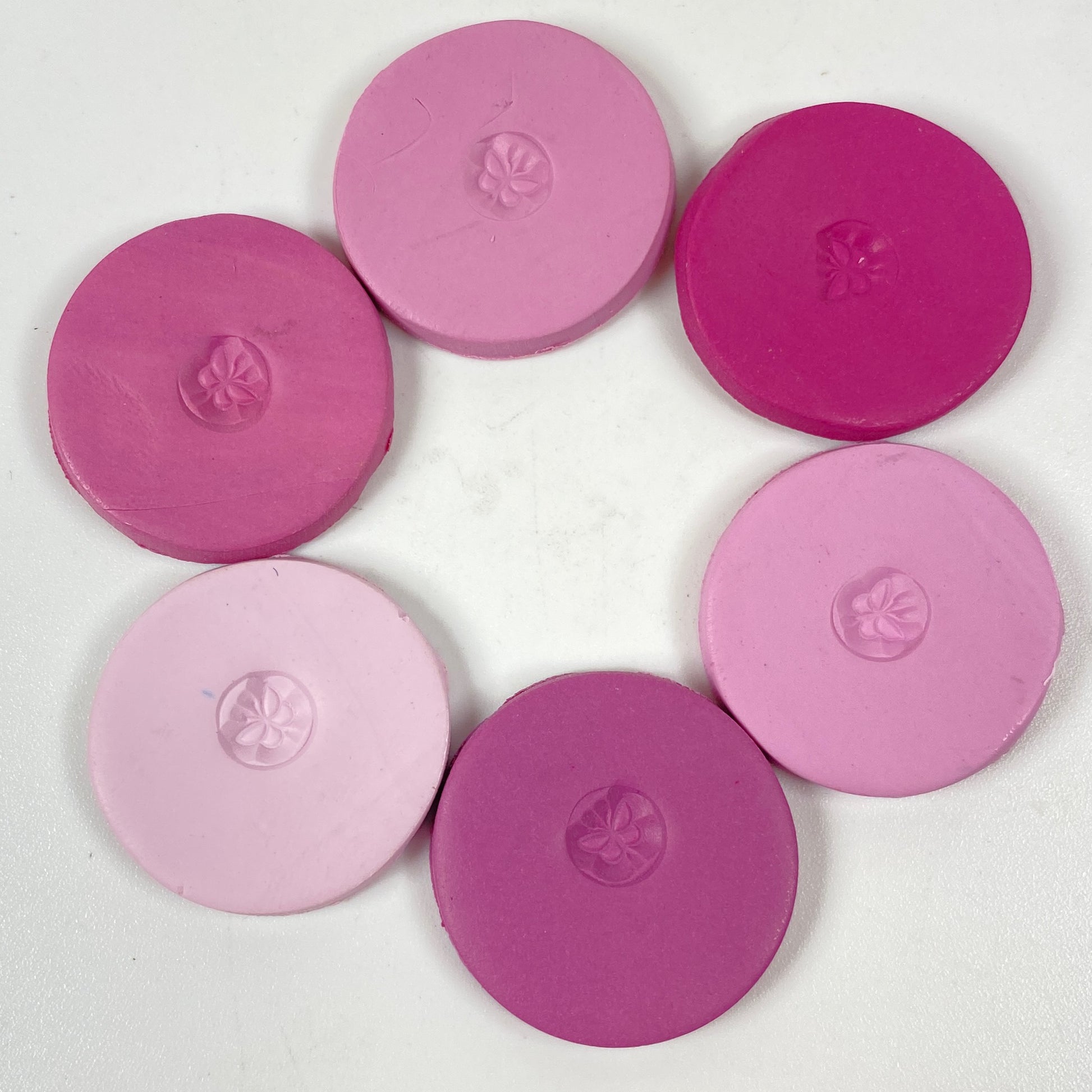 Discs of Polymer Clay in all 6 pink and purple colors of this palette, arranged in a ring.