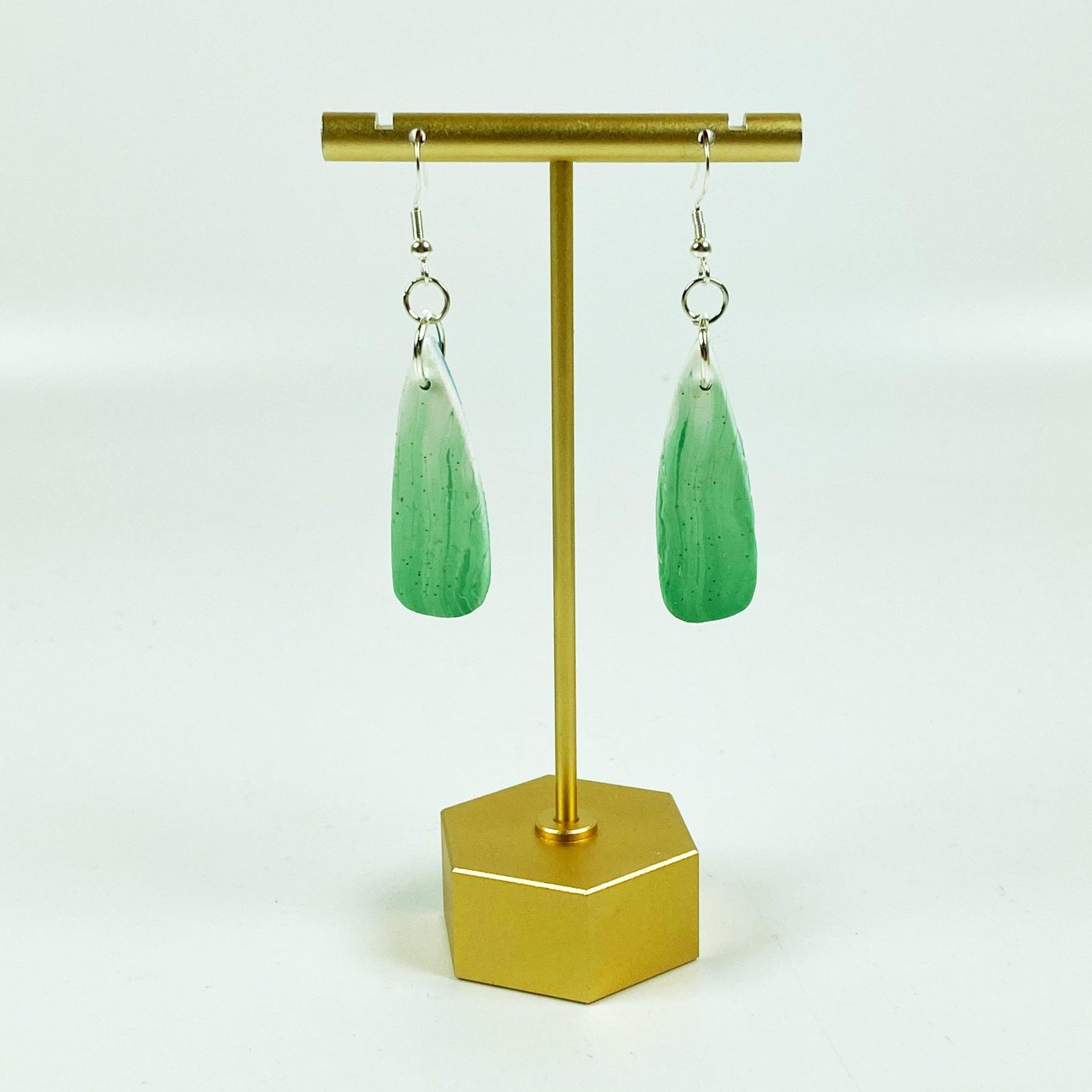 Green Aurora Polymer Clay Handmade Dangle Earrings on brass display stand