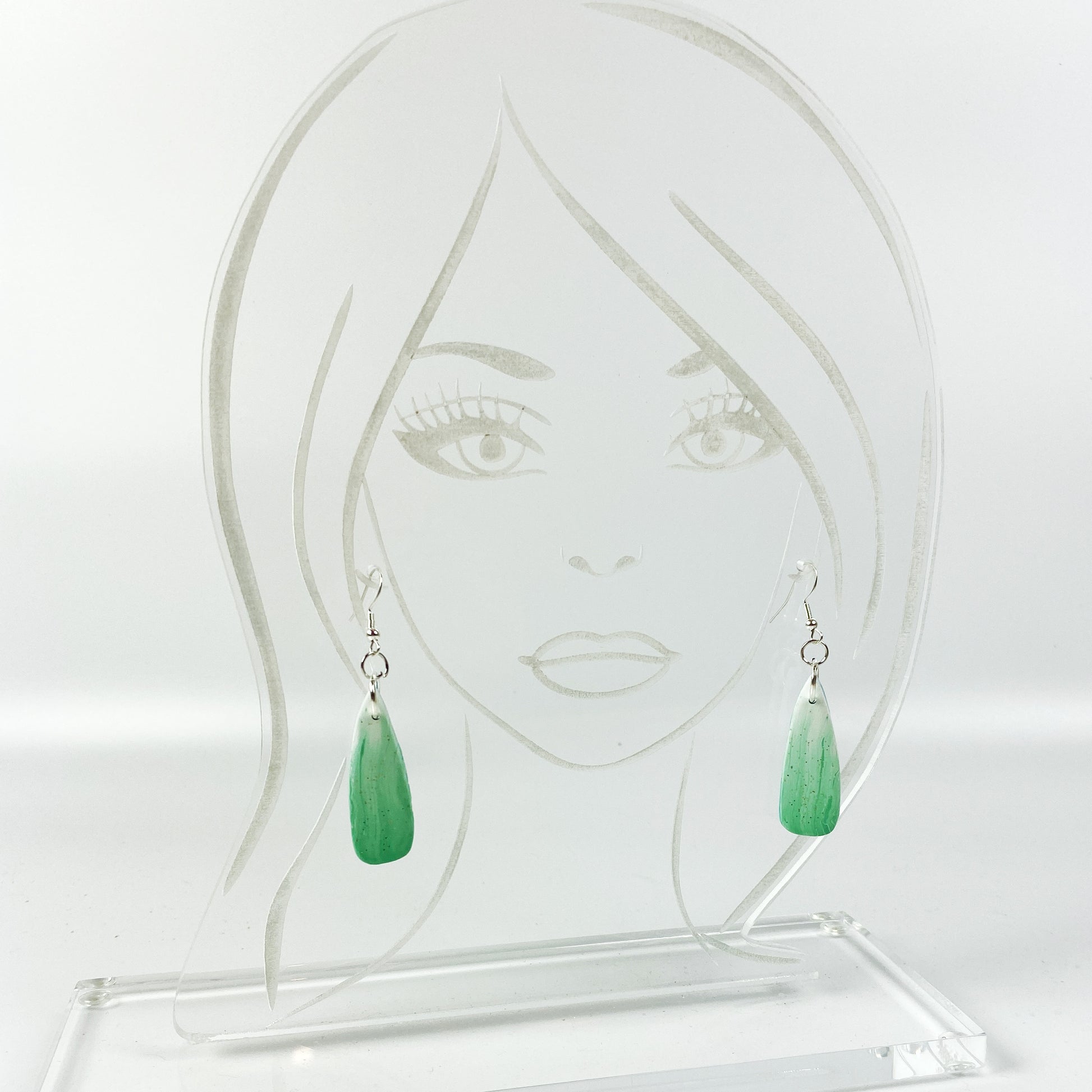 Green Aurora Polymer Clay Handmade Dangle Earrings on an acrylic display head