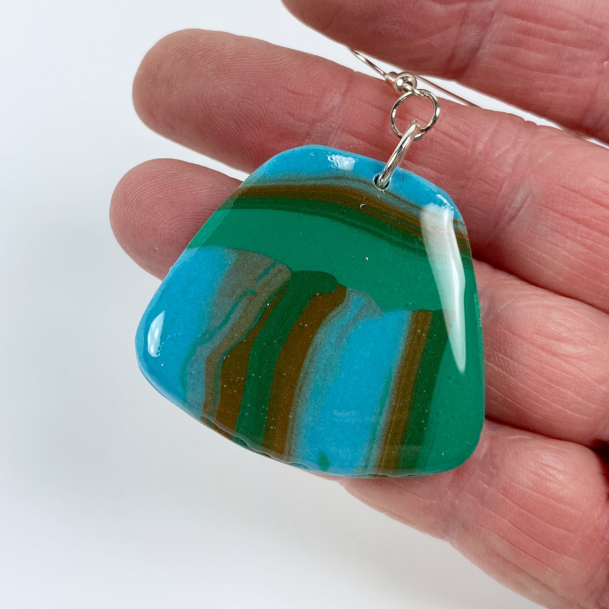 Hip Stripes Handmade Polymer Clay Dangle Earrings hand held for size reference