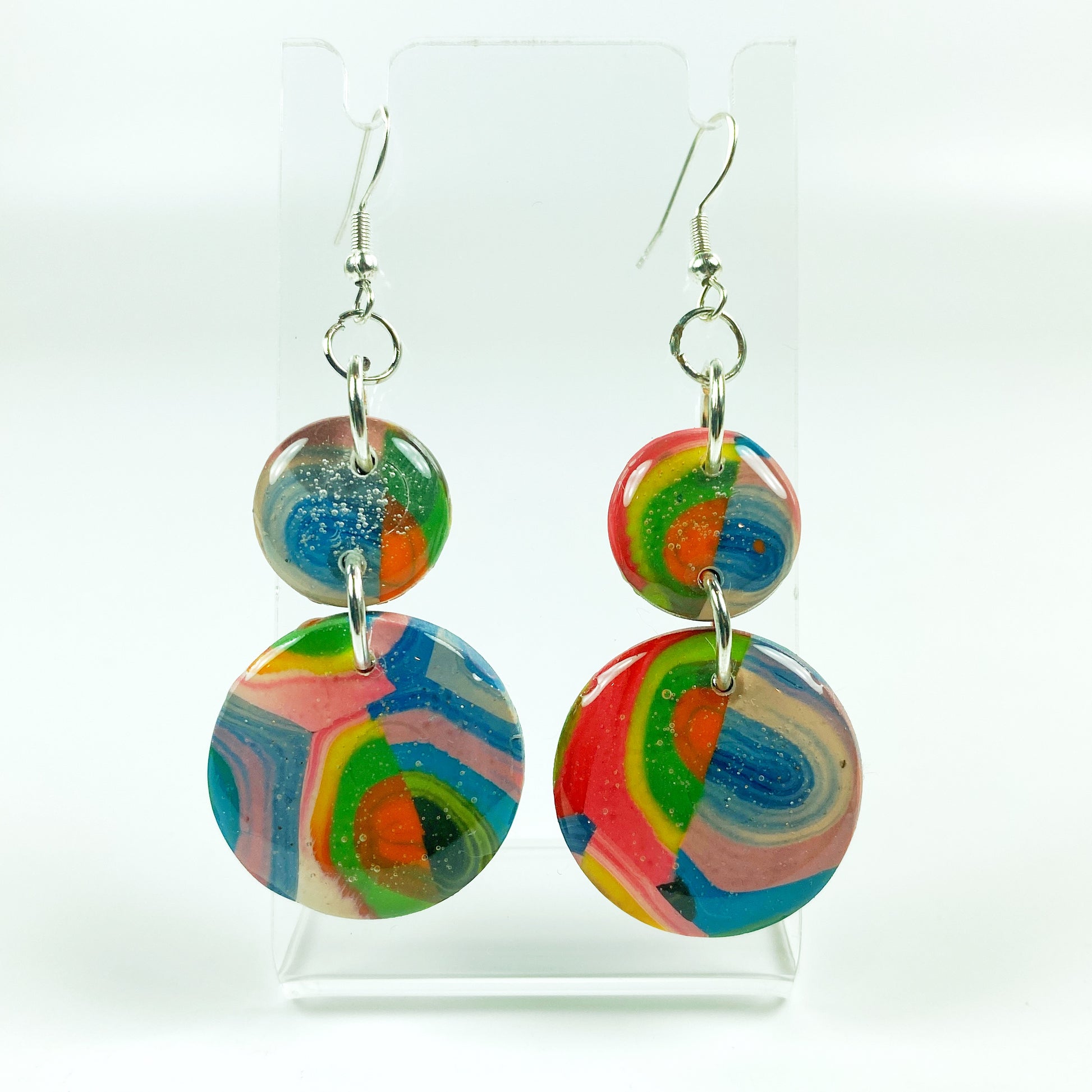 Double Kaleidoscope Multicolor Polymer Clay Dangle Earrings on small acrylic display stand