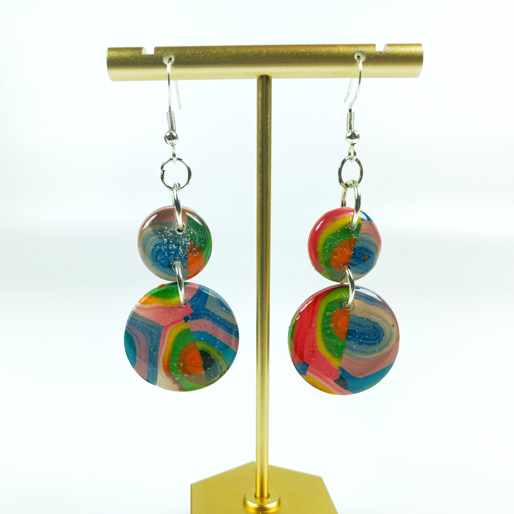 Double Kaleidoscope Multicolor Polymer Clay Dangle Earrings on brass display stand